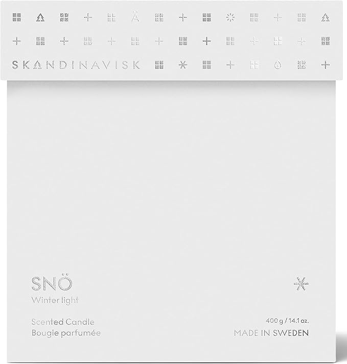 Skandinavisk SNÖ 'Snow' Scented Candle with 2 Wicks. Fragrance Notes: Frozen Forests and Frosted Berries, The Sharp Breath of Subzero Skies. 14.1 oz.