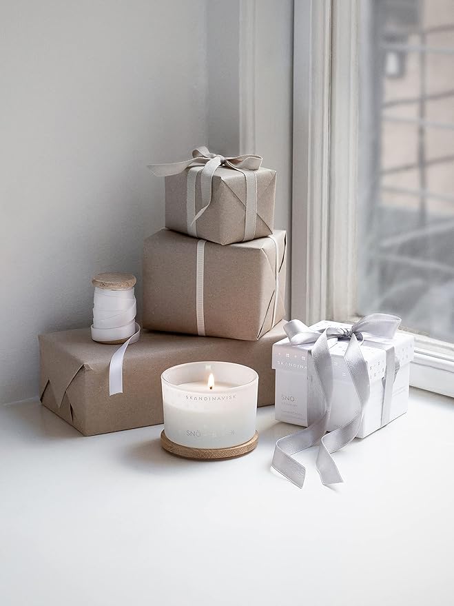 Skandinavisk SNÖ 'Snow' Scented Candle. Fragrance Notes: Frozen Forests and Frosted Berries, The Sharp Breath of Subzero Skies. 3.17 oz.